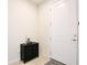 Clean foyer area with a black cabinet, neutral walls, and tile flooring near the front door at 5025 Walker St, St Cloud, FL 34771