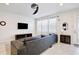 Cozy living room featuring tile floors, a ceiling fan, and large windows at 5025 Walker St, St Cloud, FL 34771