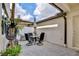 Cozy outdoor patio featuring brick pavers, a dining set with umbrella, and lush potted plants at 5025 Walker St, St Cloud, FL 34771