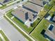 Aerial view showcases a home with solar panels, well-kept lawn, and a fenced backyard on a sunny day at 5301 Amersham Ln, St Cloud, FL 34771