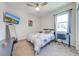 Bedroom featuring a ceiling fan, a TV on the wall, and a view of the backyard at 5301 Amersham Ln, St Cloud, FL 34771