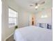 Bright bedroom features a ceiling fan and view to bathroom at 5301 Amersham Ln, St Cloud, FL 34771