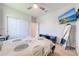 Bedroom with closet, TV, ceiling fan and view of the entry door and hallway at 5301 Amersham Ln, St Cloud, FL 34771