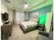 A modern bedroom featuring a tray ceiling, neutral colors, and a large flat-screen TV at 5301 Amersham Ln, St Cloud, FL 34771