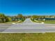 A wide view of the Lancaster Park East community entrance with beautiful landscaping and serene ponds at 5301 Amersham Ln, St Cloud, FL 34771