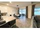 Dining area adjacent to the kitchen featuring a modern table, pendant lighting, and patio access at 5301 Amersham Ln, St Cloud, FL 34771