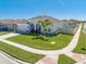 Charming one-story home featuring arched entryway, lush lawn, and attached two-car garage at 5301 Amersham Ln, St Cloud, FL 34771