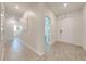 Bright hallway featuring wood-look tile flooring and views into other living spaces at 5301 Amersham Ln, St Cloud, FL 34771