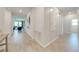 Bright hallway with tile flooring leading to the living area, showcasing an open floor plan at 5301 Amersham Ln, St Cloud, FL 34771