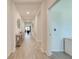 Bright hallway featuring wood-look tile flooring and views into other living spaces at 5301 Amersham Ln, St Cloud, FL 34771