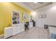 Bright home office with yellow accent wall, stylish furnishings and built in white shelving at 5301 Amersham Ln, St Cloud, FL 34771