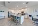 A spacious kitchen with island seating connects to a dining area, perfect for modern living and entertaining at 5301 Amersham Ln, St Cloud, FL 34771