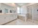 Bright bathroom with double vanity, soaking tub, and a glass-enclosed shower at 5301 Amersham Ln, St Cloud, FL 34771