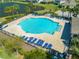 Aerial view of a community pool featuring plenty of seating near community homes at 5301 Amersham Ln, St Cloud, FL 34771