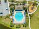 Aerial view of a community pool with plenty of seating and playground nearby at 5301 Amersham Ln, St Cloud, FL 34771