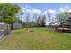 Large, grassy backyard showcasing a storage shed and ample space for outdoor activities at 5990 Hibiscus Rd, Orlando, FL 32807