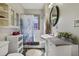 Well-lit bathroom featuring a patterned shower curtain, and a decorative oval mirror at 5990 Hibiscus Rd, Orlando, FL 32807