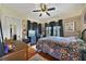 Comfortable bedroom with hardwood floors, a ceiling fan, and natural light at 5990 Hibiscus Rd, Orlando, FL 32807