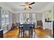 Inviting dining area with hardwood floors, chandelier, and natural light from large windows at 5990 Hibiscus Rd, Orlando, FL 32807