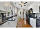 Bright kitchen with white cabinetry, black countertops, and modern appliances at 5990 Hibiscus Rd, Orlando, FL 32807