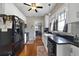 Well-lit kitchen featuring white cabinets, black countertops, and hardwood floors at 5990 Hibiscus Rd, Orlando, FL 32807