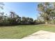 A wide backyard provides ample space, green grass, and a concrete patio at 6222 Fox Hunt Trl, Orlando, FL 32808