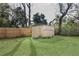 View of the backyard, featuring a storage shed and wood fence at 6222 Fox Hunt Trl, Orlando, FL 32808