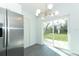 Bright kitchen area with stainless steel refrigerator and sliding glass door to backyard at 6222 Fox Hunt Trl, Orlando, FL 32808