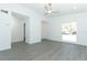 Spacious living room featuring new grey wood-look flooring, white walls, and modern ceiling fan at 6222 Fox Hunt Trl, Orlando, FL 32808