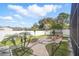 Aerial view of backyard with pavers, fire pit, trampoline, palm trees and screened in porch at 6762 Tamarind Cir, Orlando, FL 32819