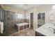 Bathroom featuring glass shower, soaking tub, and double vanity with tile floor and closet at 6762 Tamarind Cir, Orlando, FL 32819