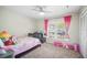 Bedroom with carpeted floor, closet, ceiling fan, and bright natural light at 6762 Tamarind Cir, Orlando, FL 32819