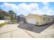 Exterior shot showing the home's backyard with a large garage and screened-in pool area at 6762 Tamarind Cir, Orlando, FL 32819