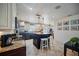 Charming kitchen featuring stainless steel appliances, a center island with barstool seating, and granite countertops at 6762 Tamarind Cir, Orlando, FL 32819