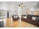 Open-concept living room featuring hardwood floors, a ceiling fan, and ample seating at 6762 Tamarind Cir, Orlando, FL 32819