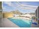 Screened-in in-ground pool with views of the backyard at 6762 Tamarind Cir, Orlando, FL 32819