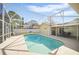 Screened-in in-ground pool with patio furniture and views of backyard at 6762 Tamarind Cir, Orlando, FL 32819