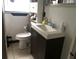 Compact bathroom featuring a stylish vanity and a sleek toilet at 7018 Stockholm Way, Orlando, FL 32822