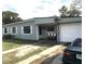 Modest single-story home with a light gray paint scheme and attached garage at 7018 Stockholm Way, Orlando, FL 32822