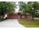 Charming single-story home featuring a two-car garage and a well-maintained front yard at 721 Waxwing Ct, Kissimmee, FL 34759