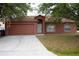 Charming single-story home featuring a two-car garage and a well-maintained front yard at 721 Waxwing Ct, Kissimmee, FL 34759