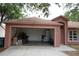 Exterior view of a single-story home with an open garage filled with boxes and household items at 721 Waxwing Ct, Kissimmee, FL 34759