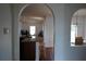 Arched entryway offering a view from the kitchen with granite countertops to the dining room at 721 Waxwing Ct, Kissimmee, FL 34759