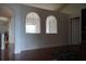 Arched entryway offering a view into the dining room from a room with glossy floors at 721 Waxwing Ct, Kissimmee, FL 34759