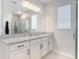 Bathroom features a large mirror, double sinks, and a glass-enclosed shower at 793 Hyperion Dr, Debary, FL 32713