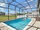 Beautiful screened-in pool area perfect for outdoor entertainment, featuring blue water and brick tile decking at 793 Hyperion Dr, Debary, FL 32713