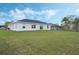 Large backyard with lush green grass and a white home at 803 Marquis Ct, Kissimmee, FL 34759