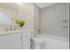 Bathroom featuring a vanity, toilet, and bathtub with gray tiled walls at 803 Marquis Ct, Kissimmee, FL 34759