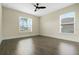 Bright bedroom with wood flooring, ceiling fan and two windows at 803 Marquis Ct, Kissimmee, FL 34759