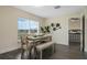 Cozy dining area features a modern table with bench seating and natural light at 803 Marquis Ct, Kissimmee, FL 34759